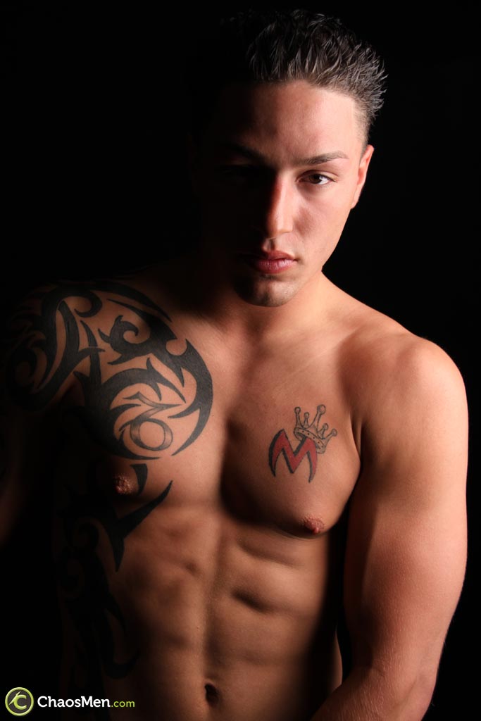 Cute inked gay Giovani exposes his dick and stokes it  