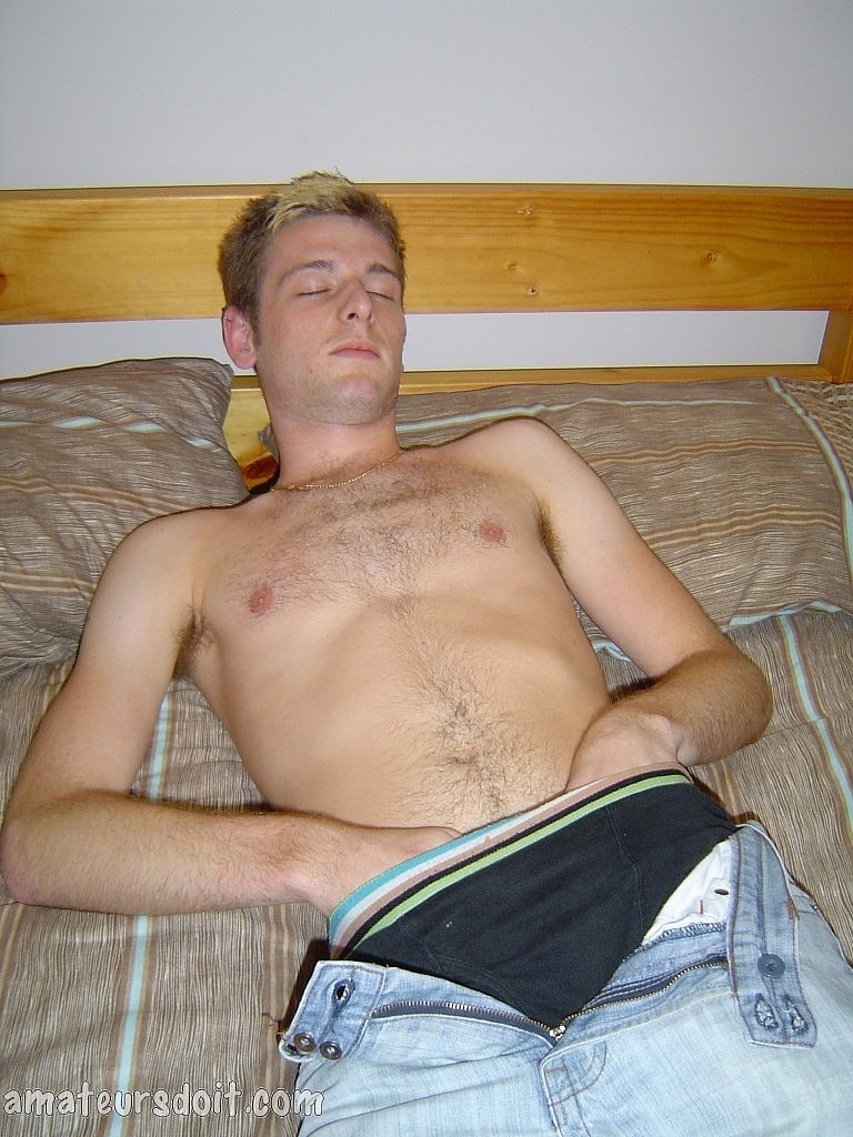 Gay amateur Richie Rider removes his jeans and touches his dick on his bed  